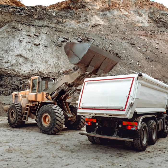 Industrial dumper trucks and wheel loader bulldozer working on highway construction